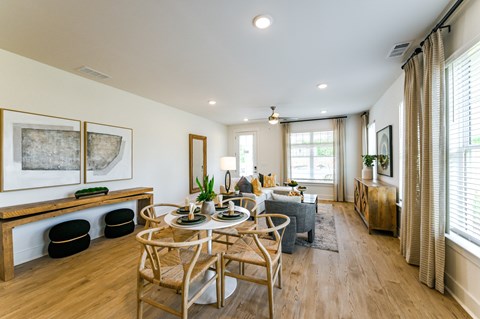 A dining room with a wooden table and chairs.