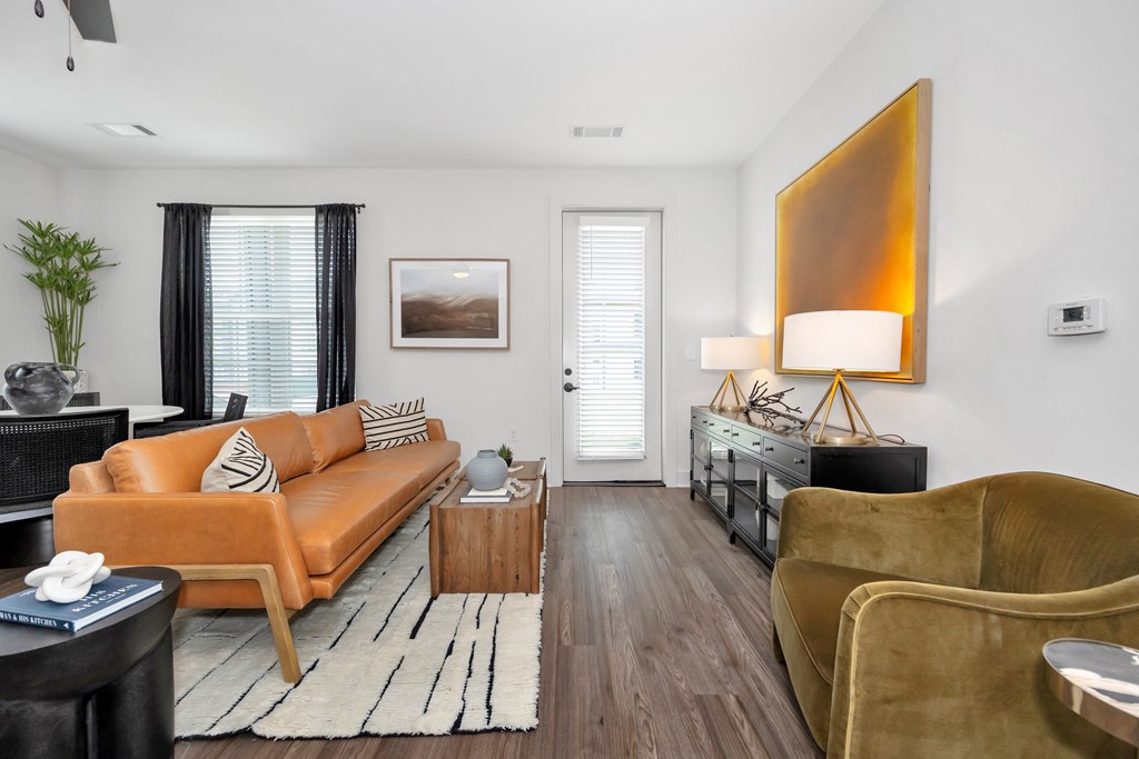 A living room with a brown couch, a yellow chair, and a wooden coffee table.