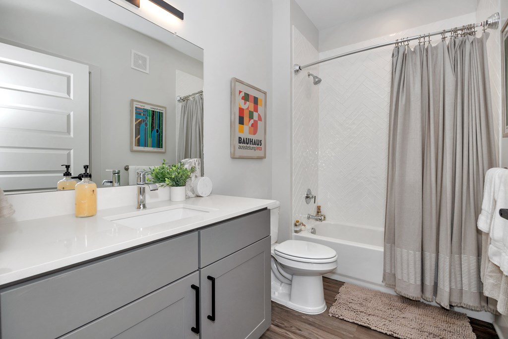 A bathroom with a white toilet and a white sink.