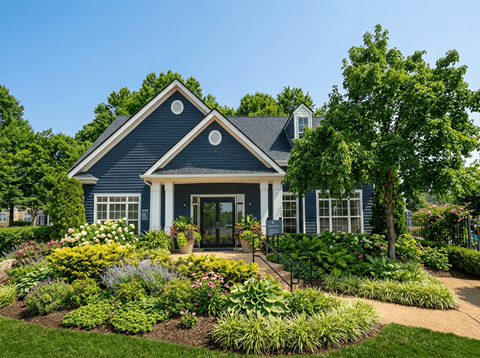 A blue house with a garden in front.