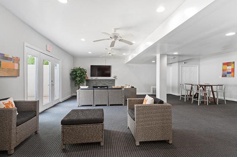 Clubhouse with chairs and tv at Barracks West apartments in Charlottesville, VA