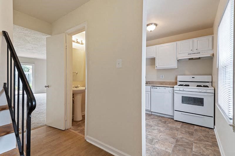 Kitchen with white appliances and tan walls at Barracks West apartments in Charlottesville, VA