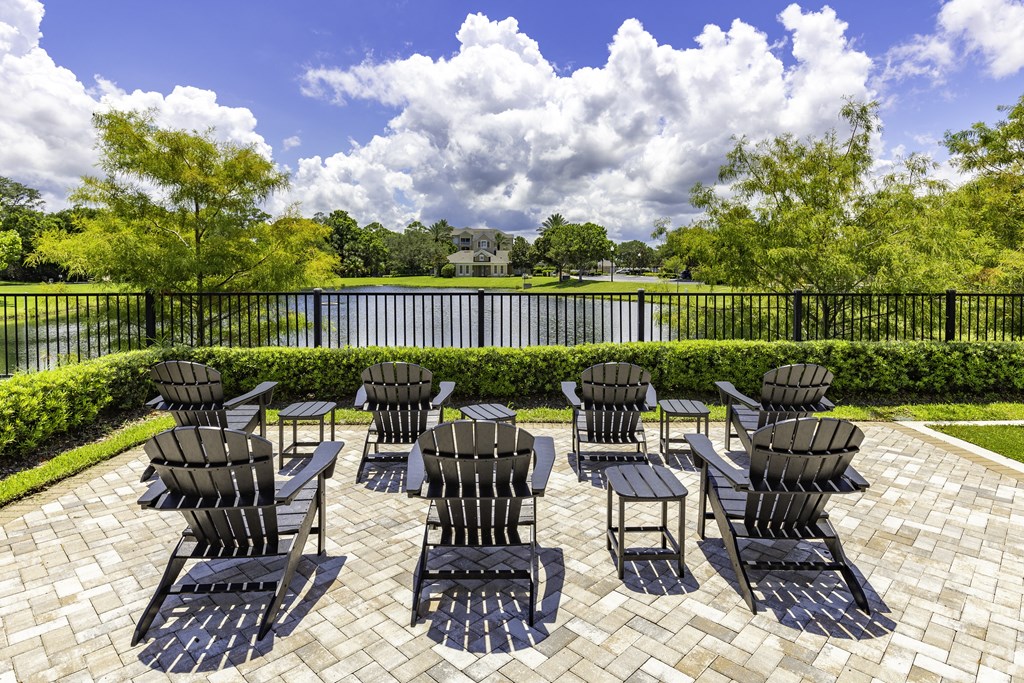 a patio with chairs and tables overlooking a lake at Ventura at Turtle Creek, Rockledge, Florida