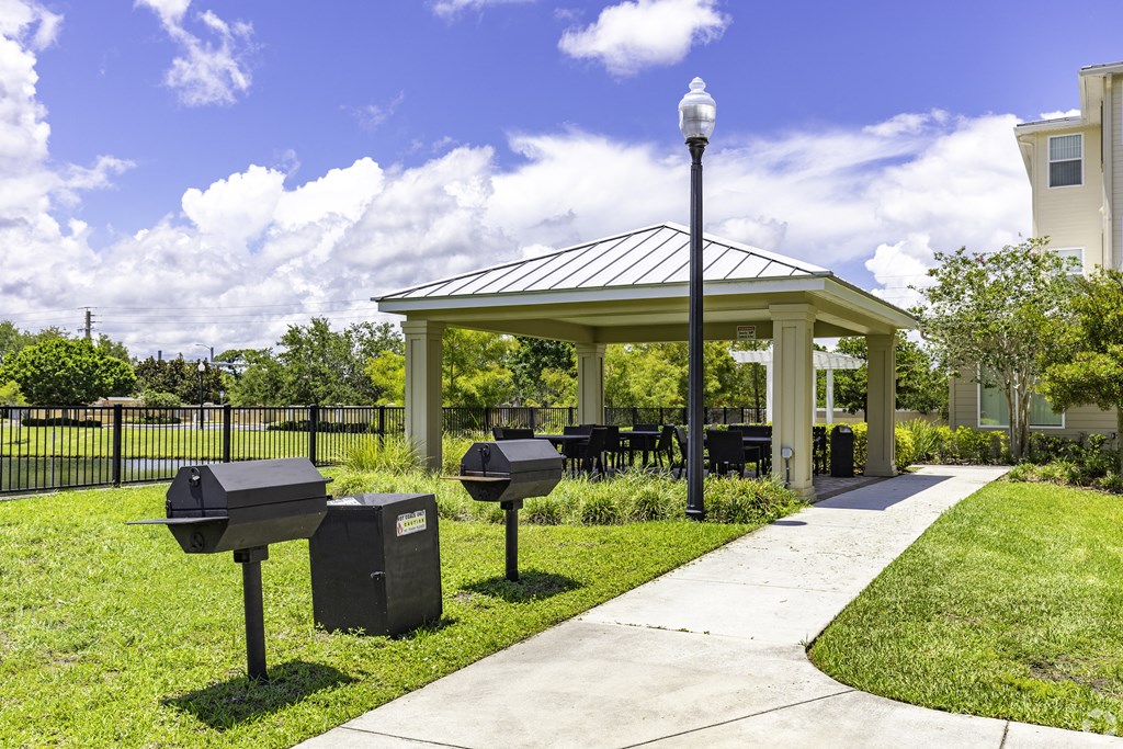 a picnic area with a pavilion and mailboxes on the grass at Ventura at Turtle Creek, Rockledge, Florida