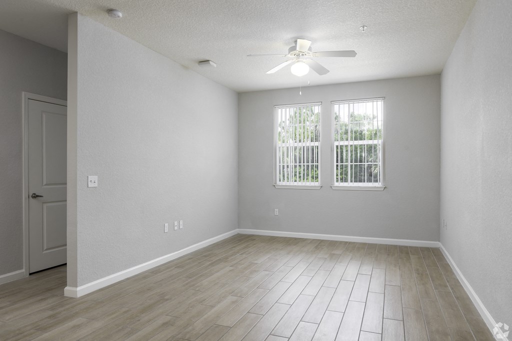 an empty living room with a ceiling fan and two windowsan empty living room with a ceiling fan and two windows  at Ventura at Turtle Creek, Florida, 32955