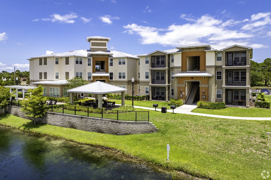 a large apartment building with a river in front of it at Turtle Creek, Florida