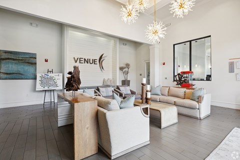 A living room with a white couch and a wooden table.