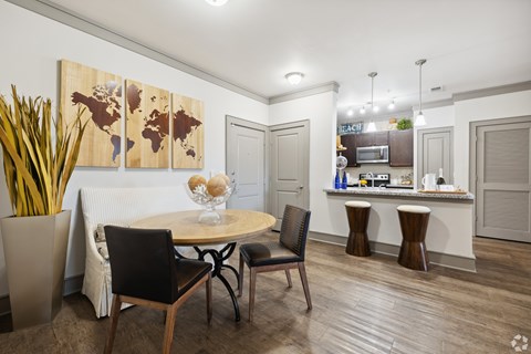 A dining room with a round table and chairs.