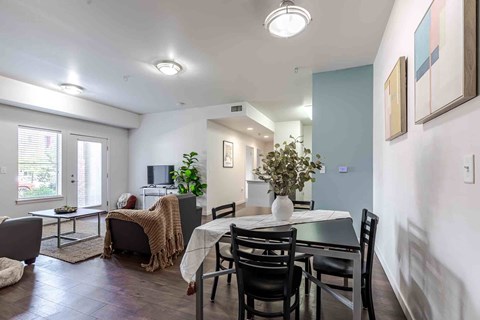 A dining room with a table set for four.
