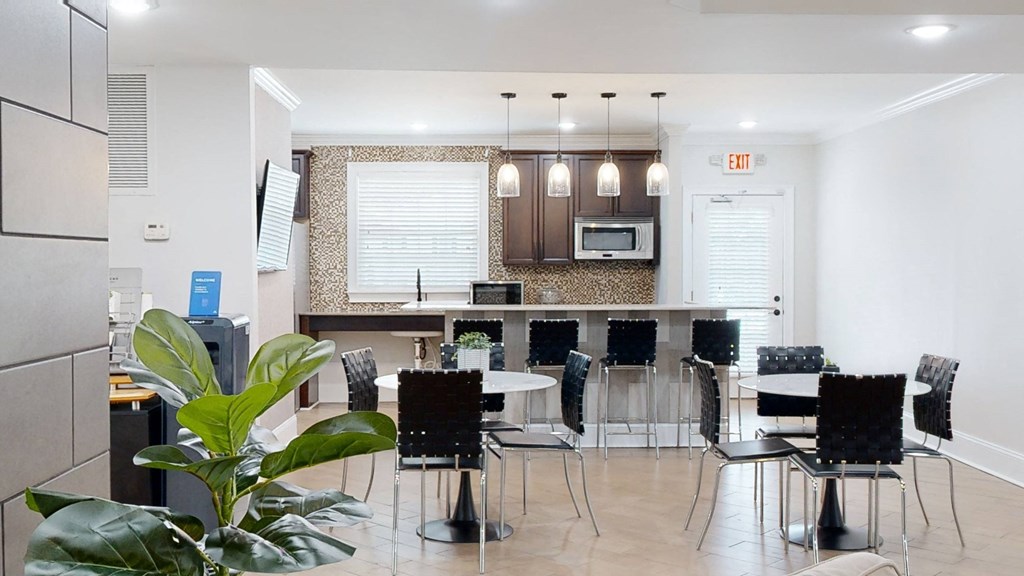 a room with a table and chairs and a kitchen in the background at Vinings RiverVue Apartments, Atlanta, GA