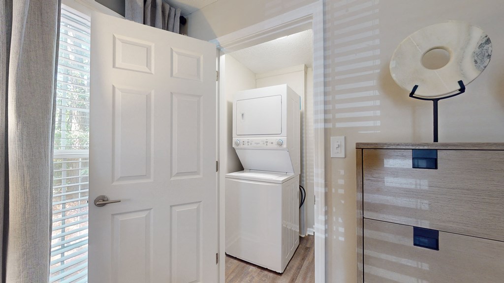 a small laundry room with a washer and dryer at Vinings RiverVue Apartments, Atlanta, GA, 30339