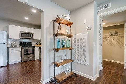 A kitchen with a white fridge and stove top oven.
