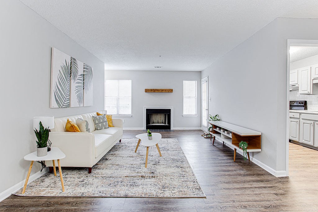 a living room with a white couch and a fireplace