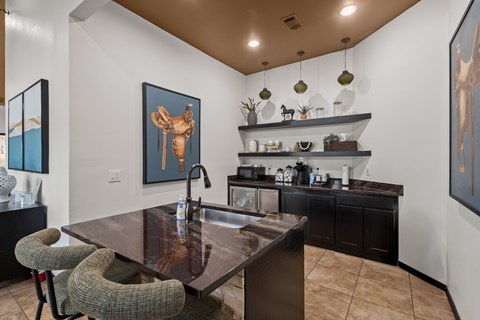 A modern kitchen with a brown table and black chairs.