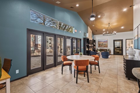 A dining room with a table set for six.