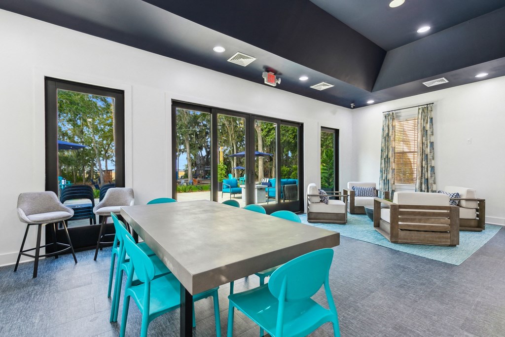 A modern dining room with a long table and chairs.