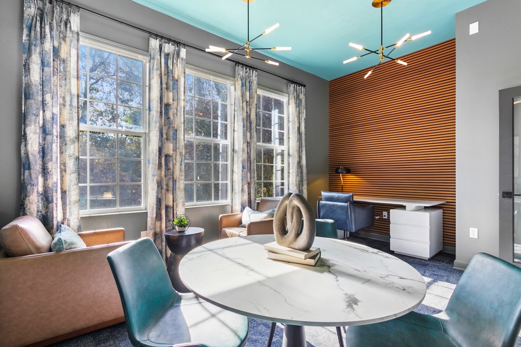A modern living room with a round table and chairs.