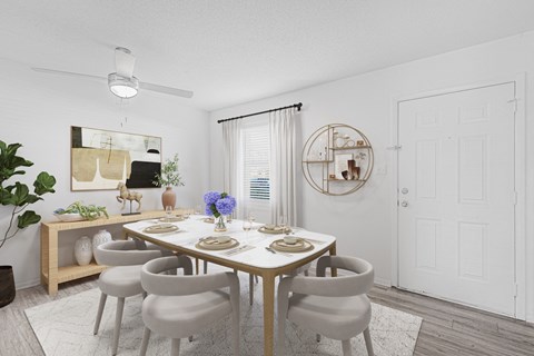 A dining room with a round table and chairs.