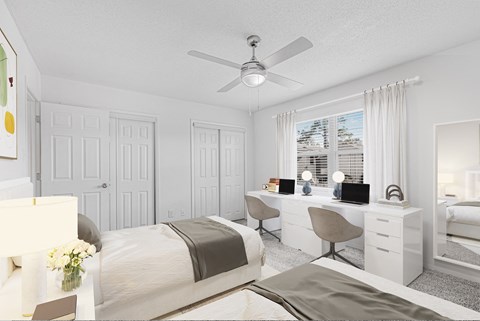 A bedroom with a bed, desk, and chair.