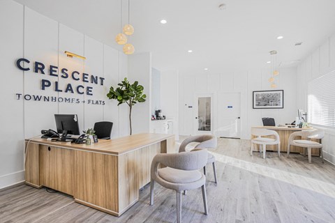 A reception area with a desk and chairs in front of a Crescent Place sign.