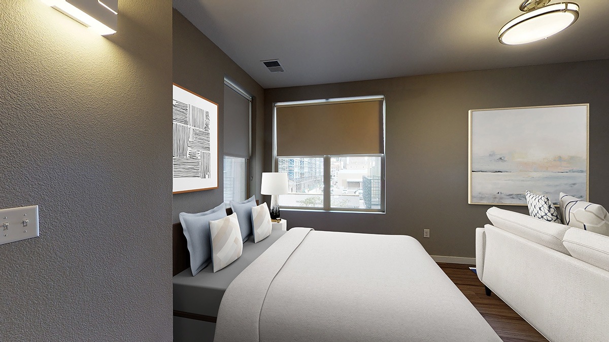 A bedroom with a large bed and a couch.