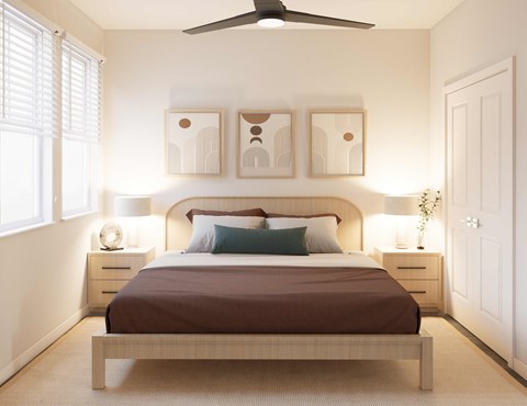A bedroom with a bed, two nightstands, and a ceiling fan.