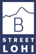 A blue and white sign with the letter B and the words "Street Lohi" on it.