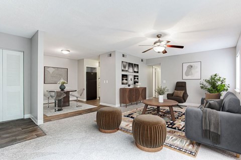 A living room with a grey couch and a wooden coffee table.