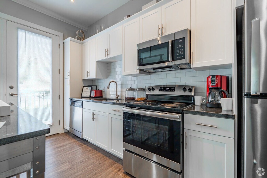 A kitchen with white cabinets and stainless steel appliances.at Century Baxter Avenue, Louisville, 40204