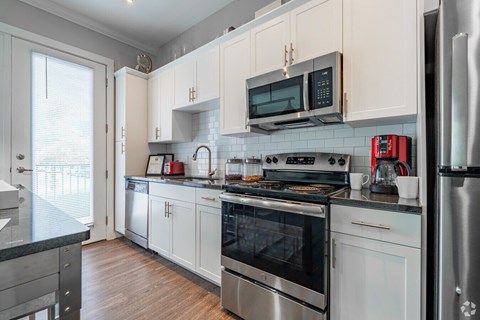 A kitchen with white cabinets and stainless steel appliances.at Century Baxter Avenue, Louisville, 40204
