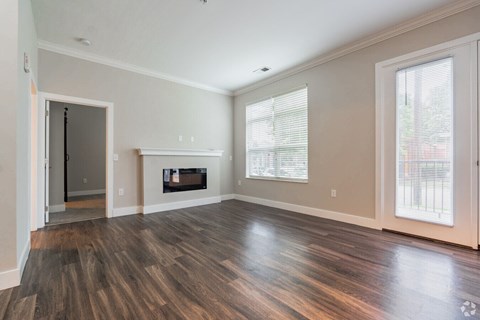 A room with a fireplace and wood flooring.at Century Baxter Avenue, Louisville, KY 40204