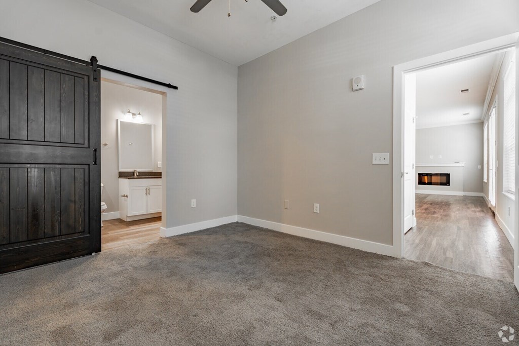 A room with a carpeted floor and a ceiling fan.at Century Baxter Avenue, Louisville