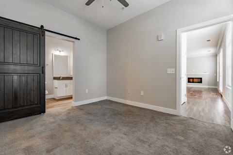A room with a carpeted floor and a ceiling fan.at Century Baxter Avenue, Louisville
