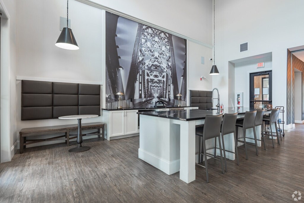 A modern kitchen with a long island and chairs.at Century Baxter Avenue, Louisville, KY