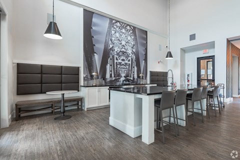 A modern kitchen with a long island and chairs.at Century Baxter Avenue, Louisville, KY