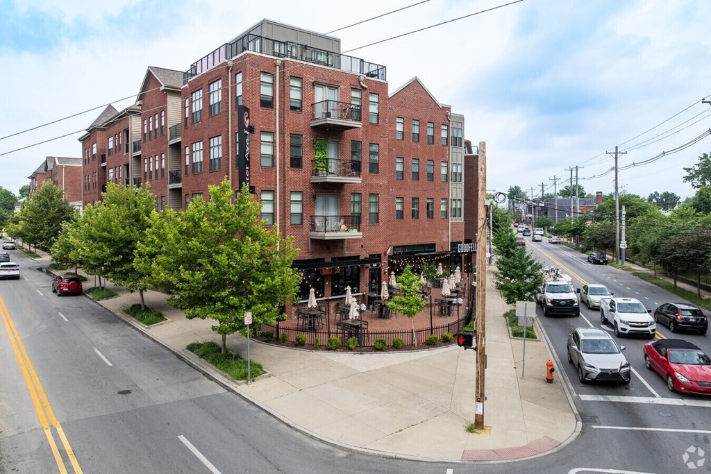A street view of a red brick building with cars parked on the side of the road.at Century Baxter Avenue, Louisville, KY 40204