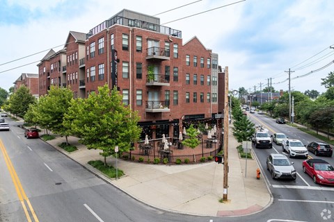 A street view of a red brick building with cars parked on the side of the road.at Century Baxter Avenue, Louisville, KY 40204