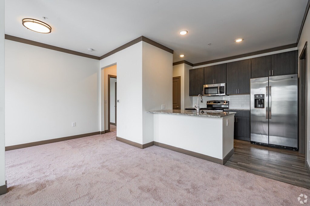 A kitchen with a white counter and stainless steel appliances. at Century Belmont Station, Louisville, KY