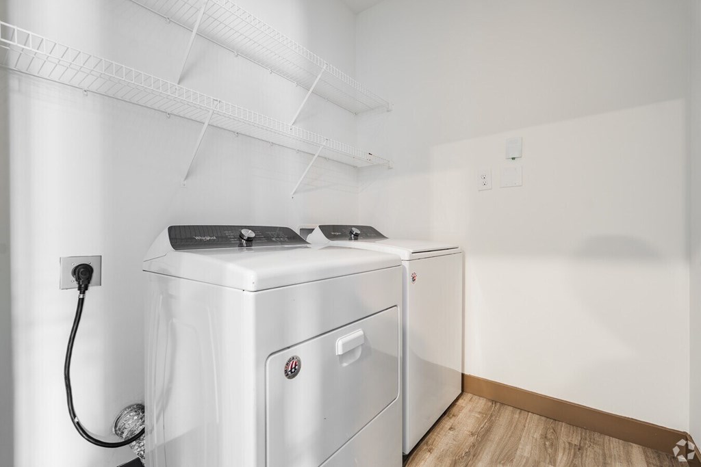 A white washing machine and dryer in a laundry room. at Century Belmont Station, Louisville, KY