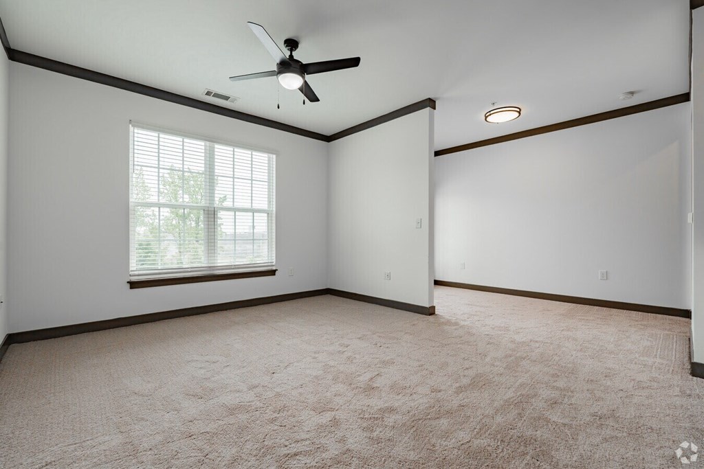 A room with a ceiling fan and a window. at Century Belmont Station, Louisville