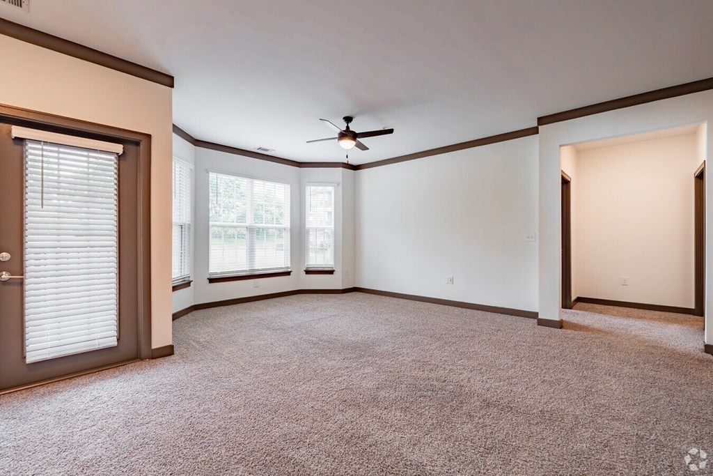 A room with a ceiling fan and a carpeted floor. at Century Belmont Station, Louisville, KY, 40243