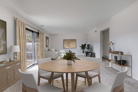 A dining room with a round table and chairs.