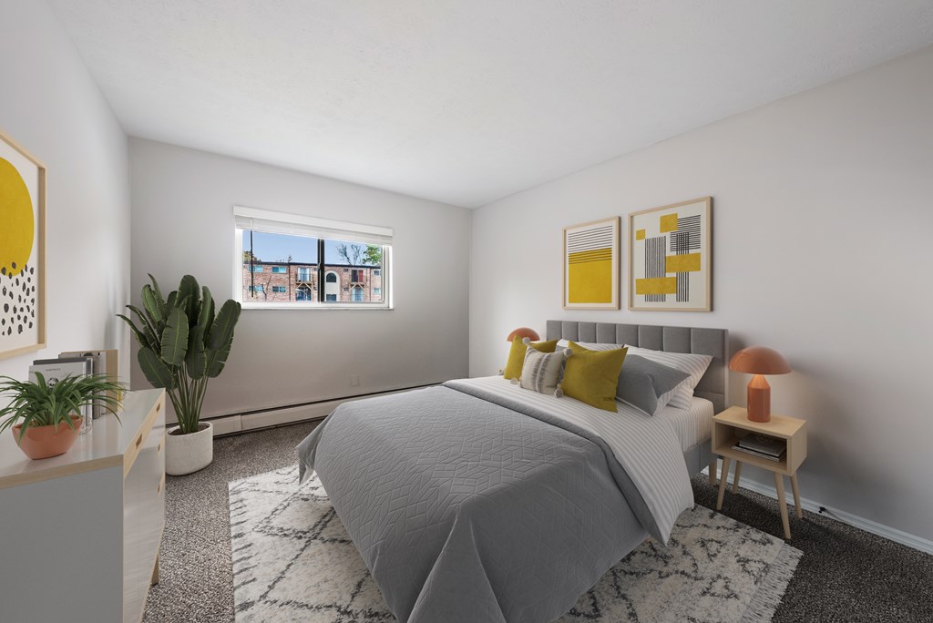 A bedroom with a bed, a nightstand, a window, and a plant.