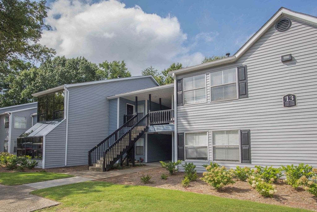 exterior view of a gray house with stairs and a porch