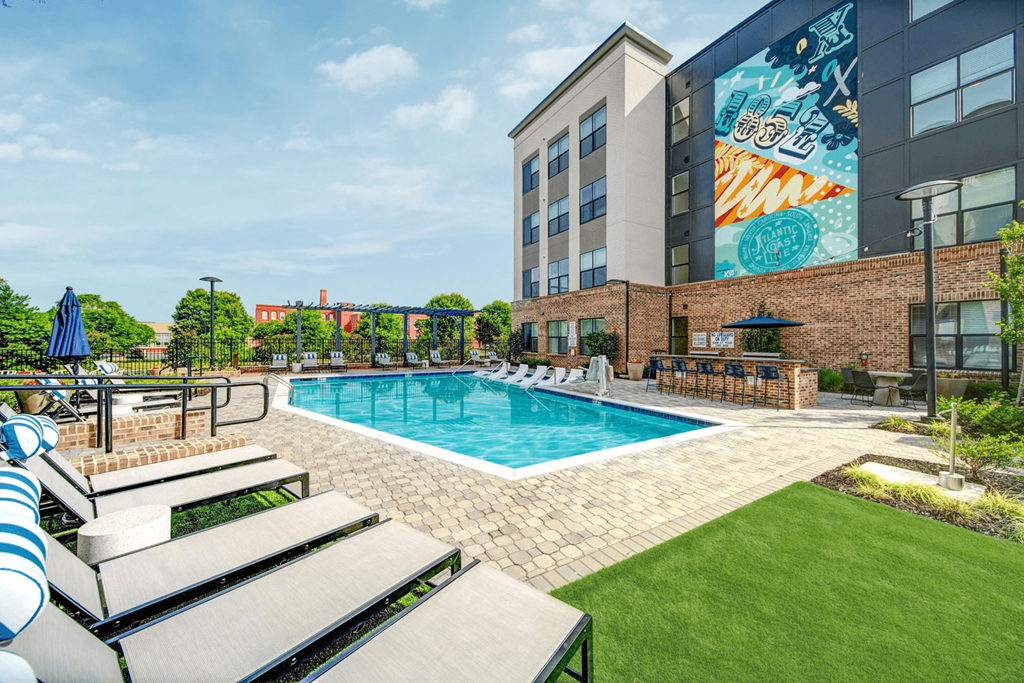 a swimming pool with a building in the background