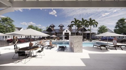 A large outdoor pool area with people sitting and standing around.