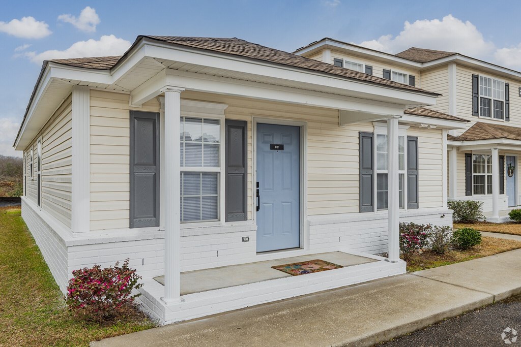 A small house with a blue door and windows.