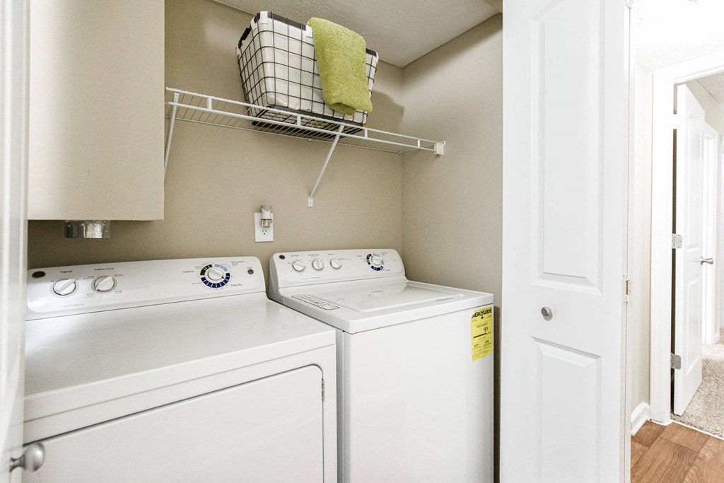 a washer and dryer in a laundry room with a door