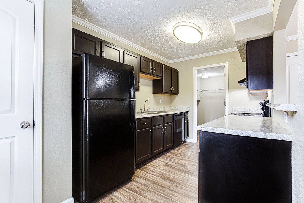 a kitchen with black appliances and a white counter top