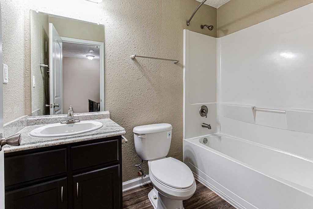 an empty bathroom with a toilet sink and tub
